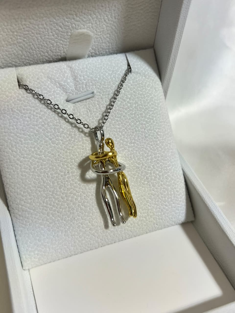Two-tone silver and gold interlocked couple necklace